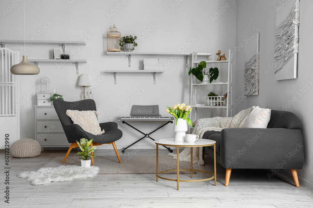 Interior of stylish living room with cozy sofa, armchair and synthesizer