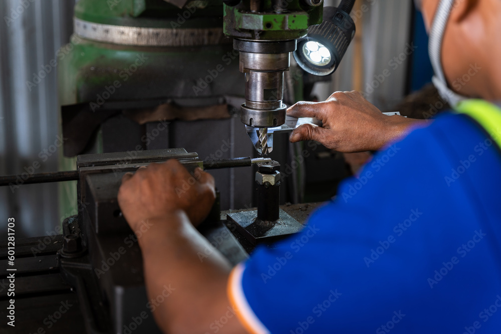 Close up of Worker uses a vernier measuring machine to inspect components for fabrication on a lathe