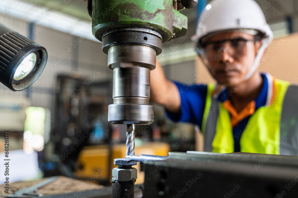 A worker operating lathe grinding machine - metalworking industry concept. Mechanical Engineering co