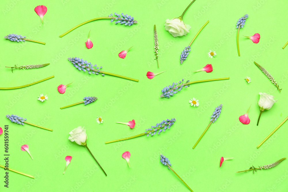 Composition with Muscari and eustoma flowers on green background