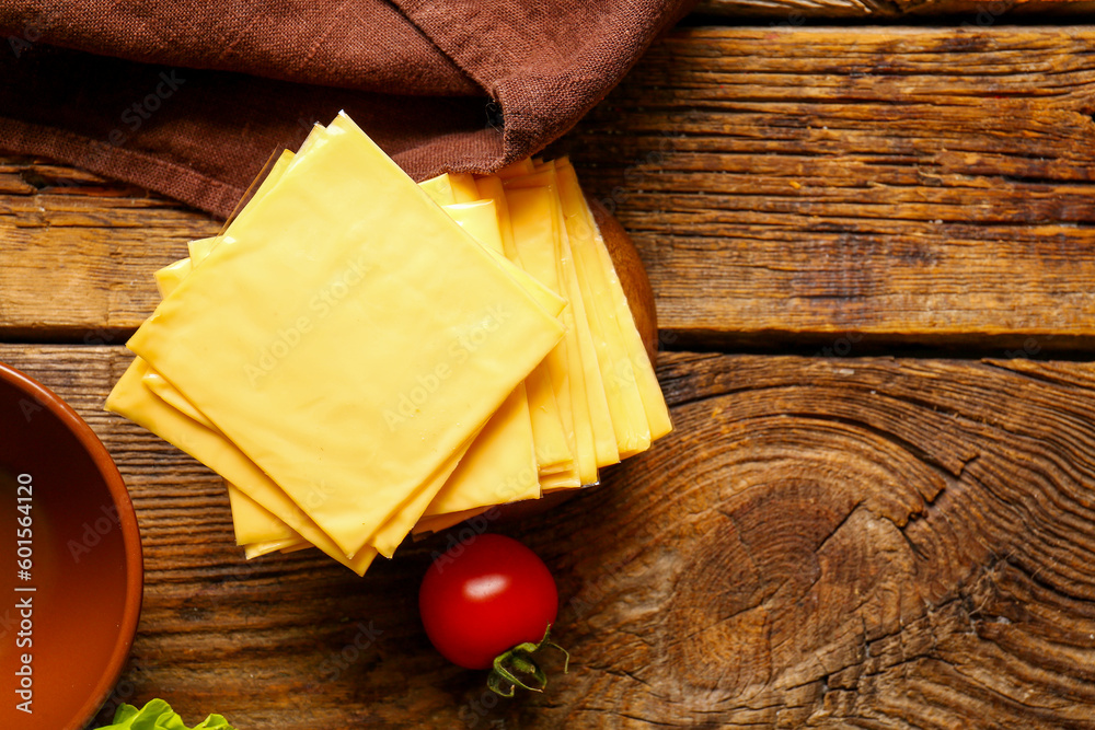 Slices of tasty processed cheese on wooden background