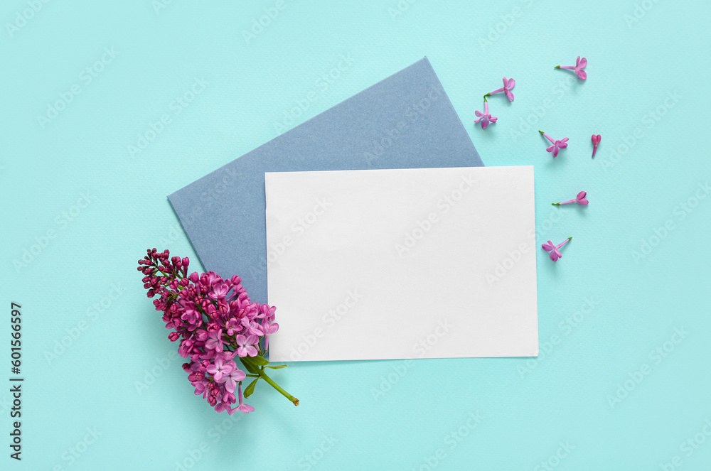 Blank card with lilac flowers on pale blue background