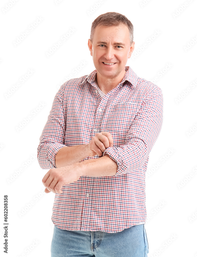 Mature man rolling up his sleeve on white background