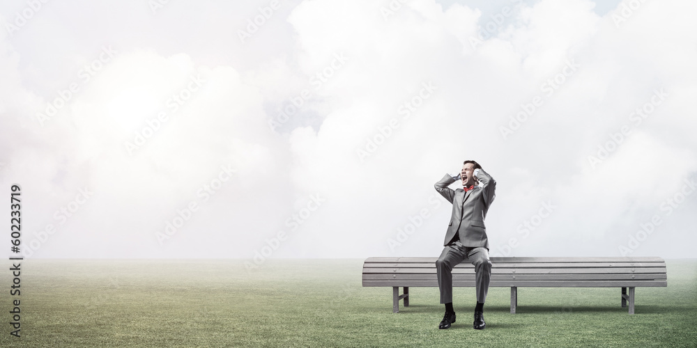 Young man in suit in park dont want to hear anything