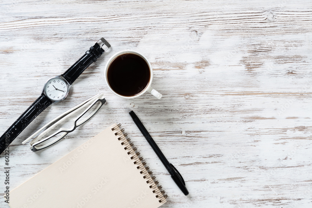 Top view office desk with white cup of coffee