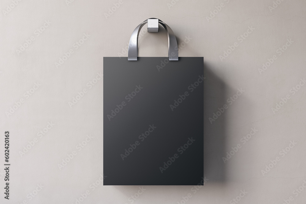 Shopping or present concept with front view on blank dark craft bag with silver handles and space fo