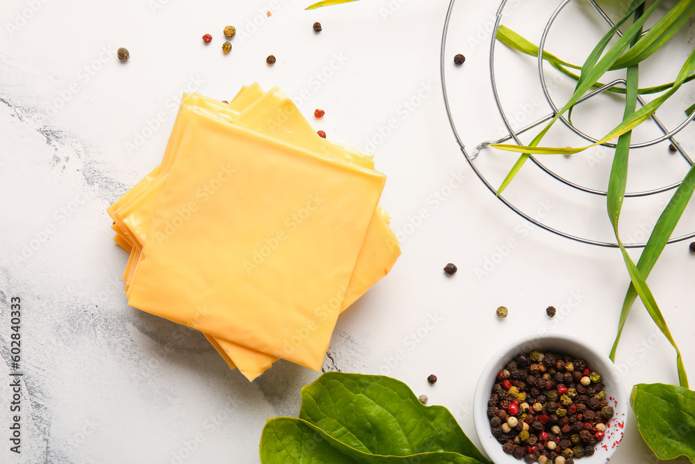 Slices of tasty processed cheese on white marble background