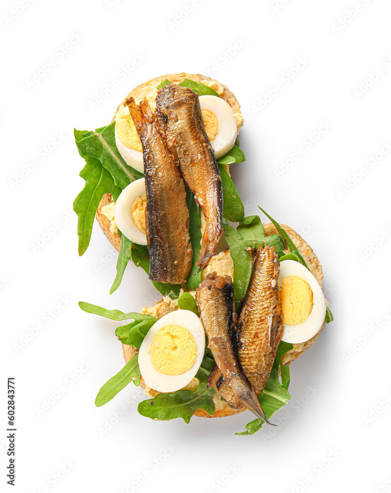 Tasty sandwiches with canned smoked sprats on white background