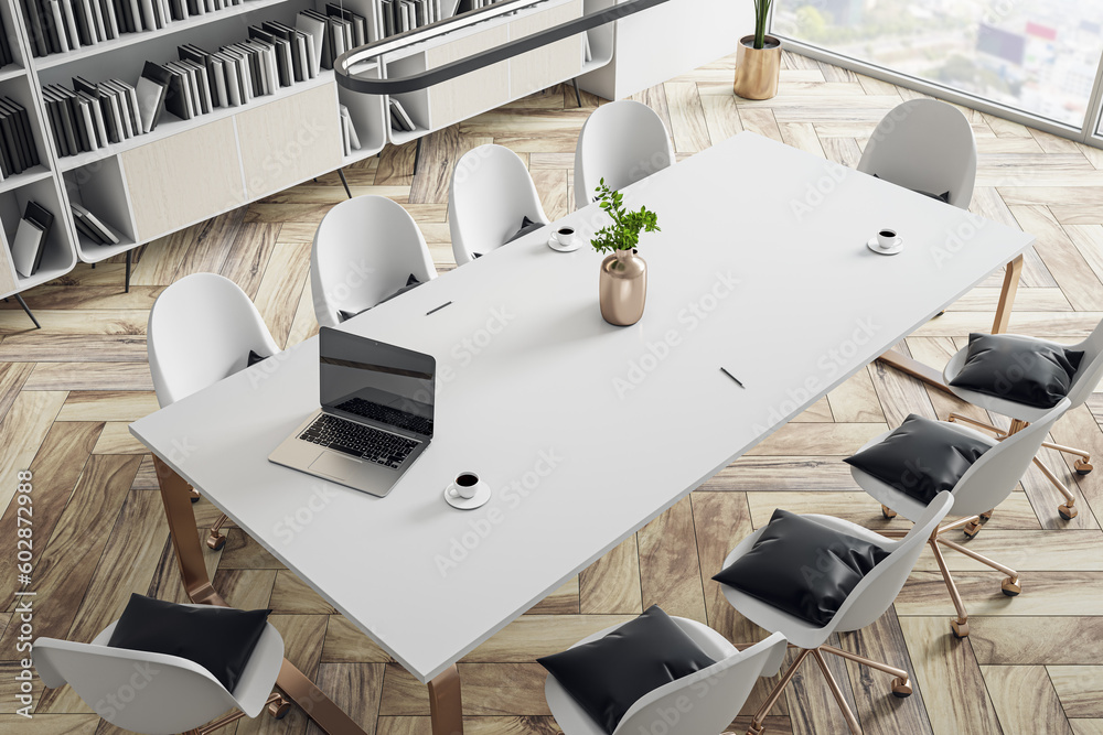 Perspective top view on white conference table with golden vase, modern laptop and coffee mug surrou