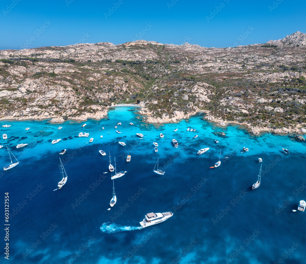 Aerial view of luxury yachts and boats on blue sea at summer sunny day. Travel in Sardinia, Italy. D