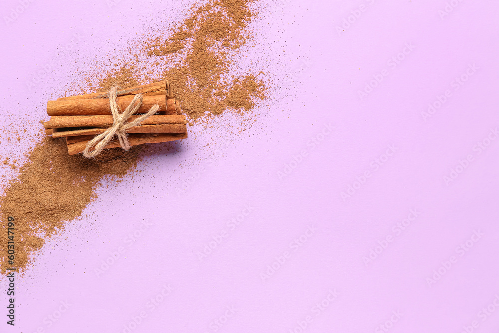 Bunch of cinnamon sticks and powder on color background