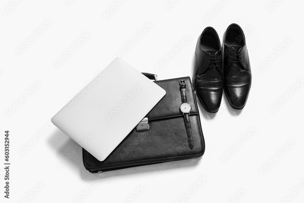 Classic male shoes with laptop and accessories on white background