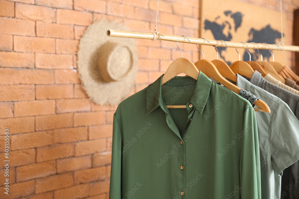 Rack with stylish female clothes in boutique, closeup