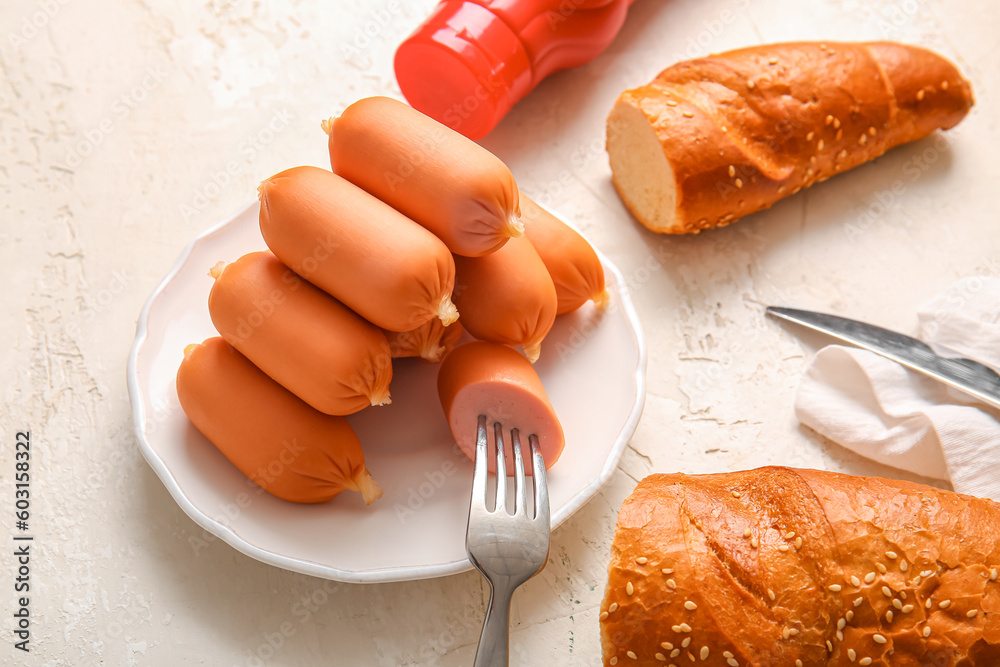 Plate of tasty boiled sausages on white background