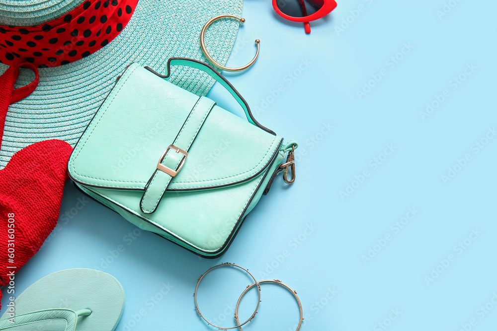 Stylish bag and different accessories on blue background