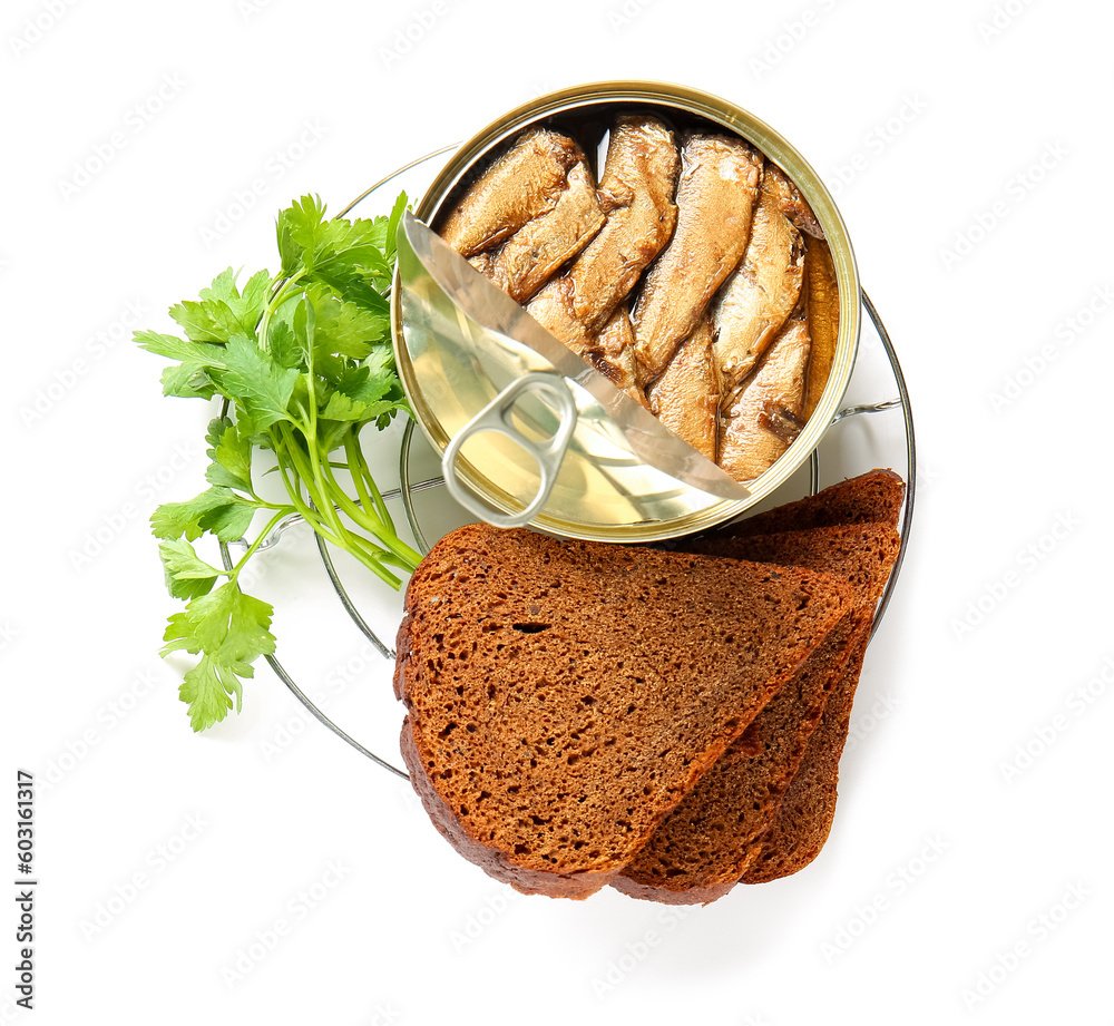 Plate of canned smoked sprats with parsley and bread on white background