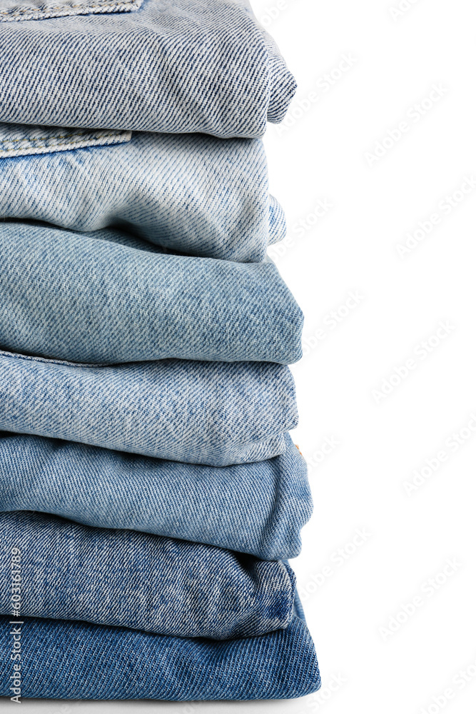 Different folded denim jeans on white background