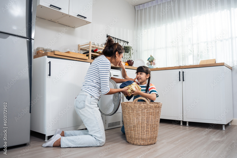 Caucasian beautiful mother teaching young daughter wash dirty clothes. 