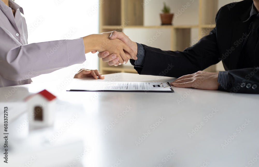 Business, career and placement concept - image of employer sitting in office and shaking hand of you