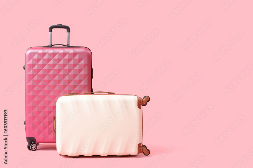 Big suitcases on pink background