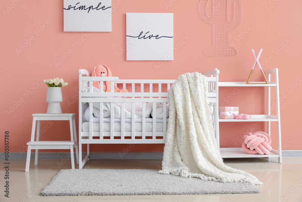 Interior of childrens bedroom with crib and shelving unit