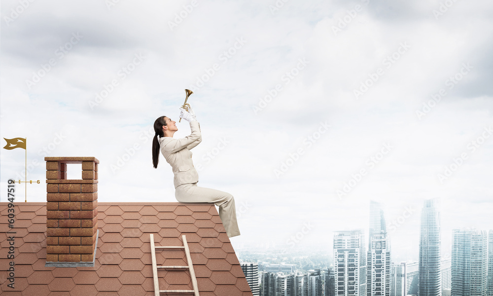 Attractive young woman playing trumpet on roof