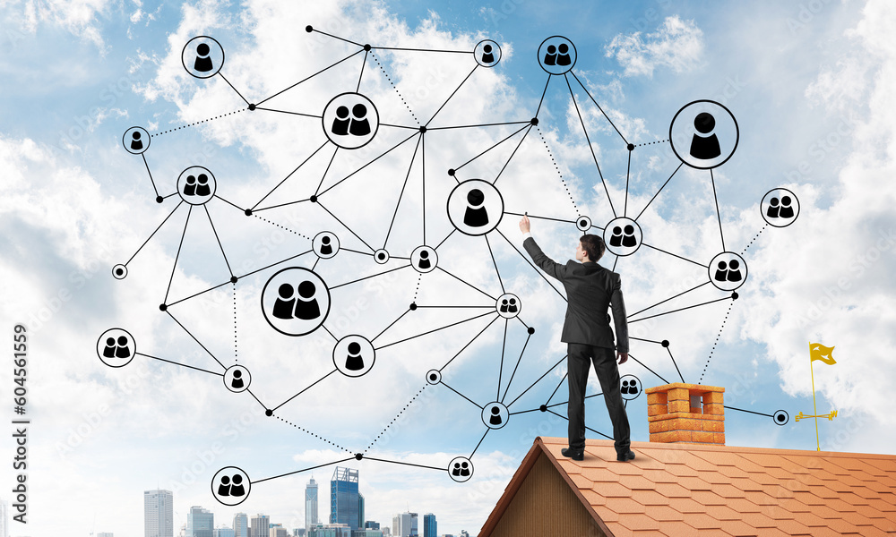 Businessman on house roof presenting networking and connection concept. Mixed media