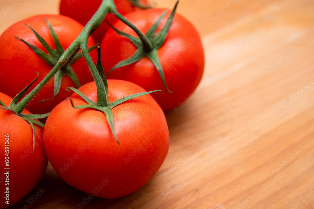 sprig of tomatoes on a wooden background