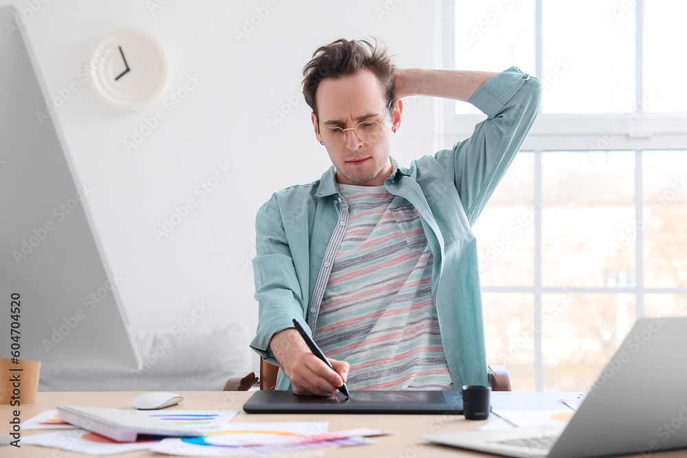 Male designer using graphic tablet in office