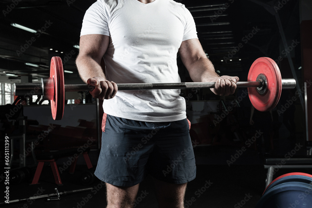 Male athlete lifts the barbell