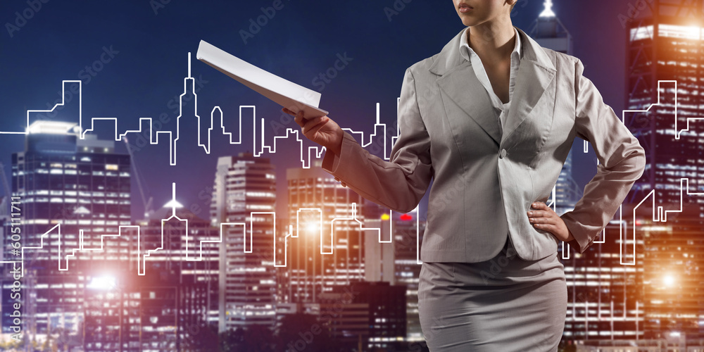 Woman architect or engineer presenting construction concept and holding documents in hand