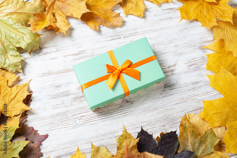 Bright autumn composition with gift box