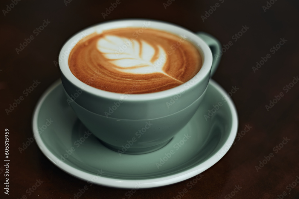 Selective focus cup of hot latte art coffee on wooden table