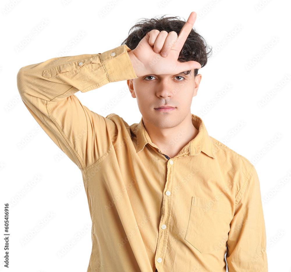 Young man showing loser gesture on white background