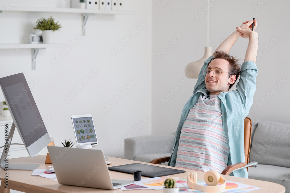 Male graphic designer relaxing in office