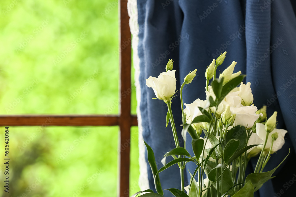 Bouquet of beautiful eustoma flowers near window