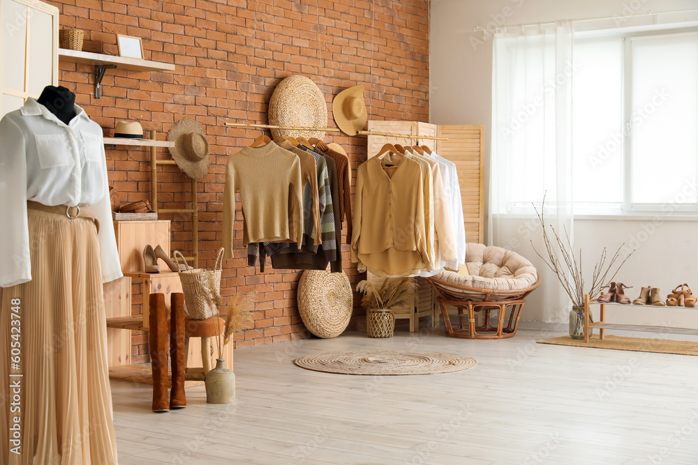 Interior of modern boutique with stylish female clothes and accessories