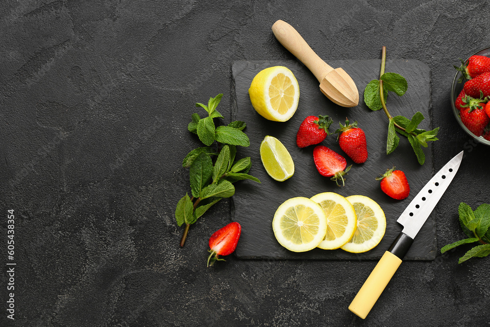 Composition with ripe strawberry, lime, lemon and mint on dark background