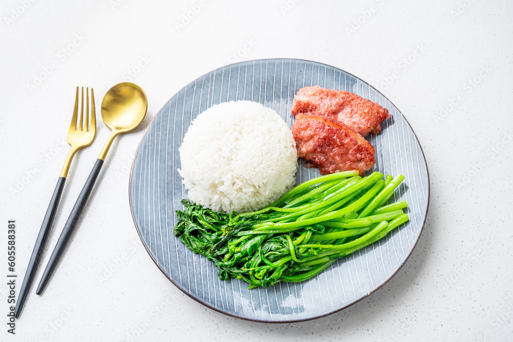 Chinese style meal for one with rice, steamed pork and stir-fried vegetables