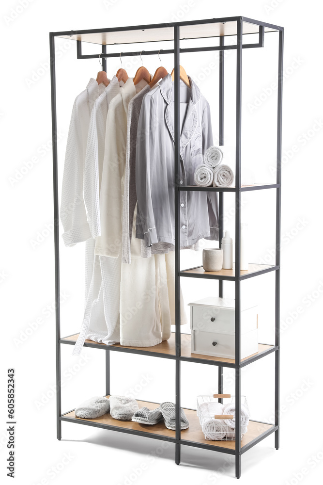 Shelving unit with pajamas and bath accessories on white background