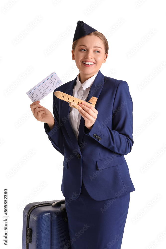 Beautiful stewardess with wooden airplane and ticket on white background