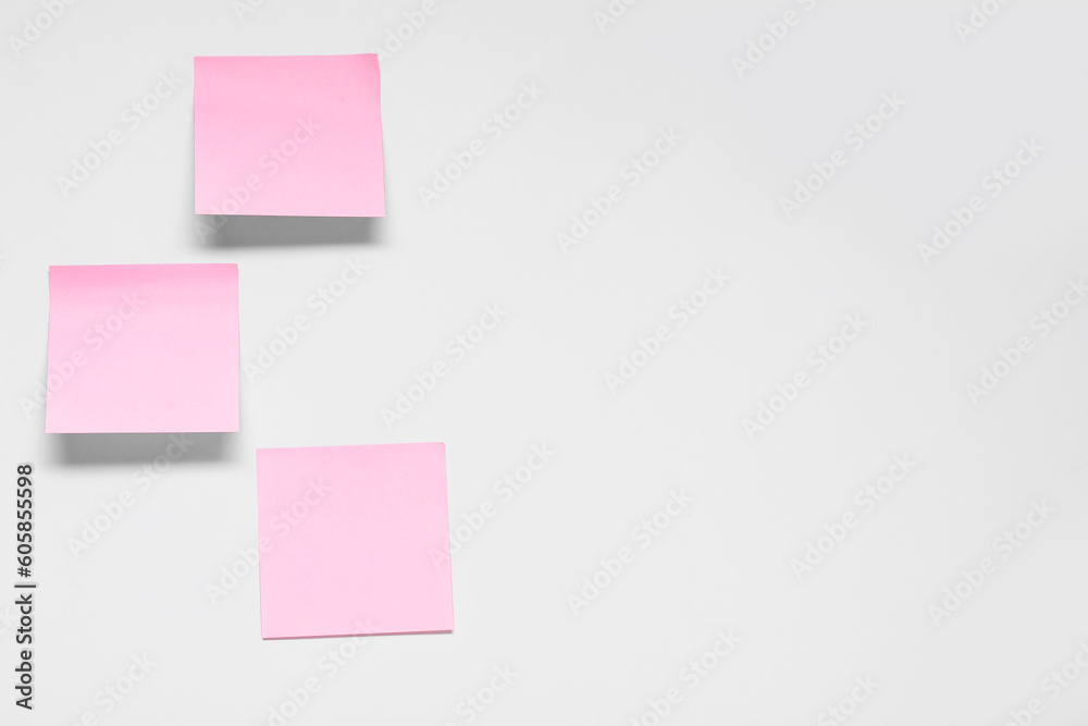 Pink sticky notes on grey background