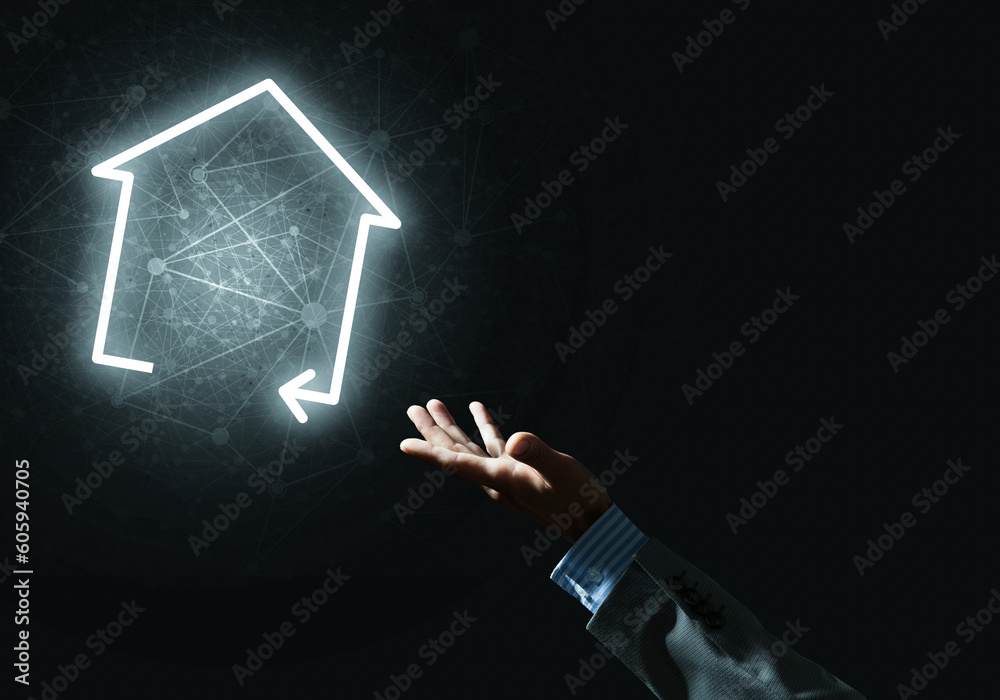 Conceptual image with hand pointing at house or main page icon on dark background