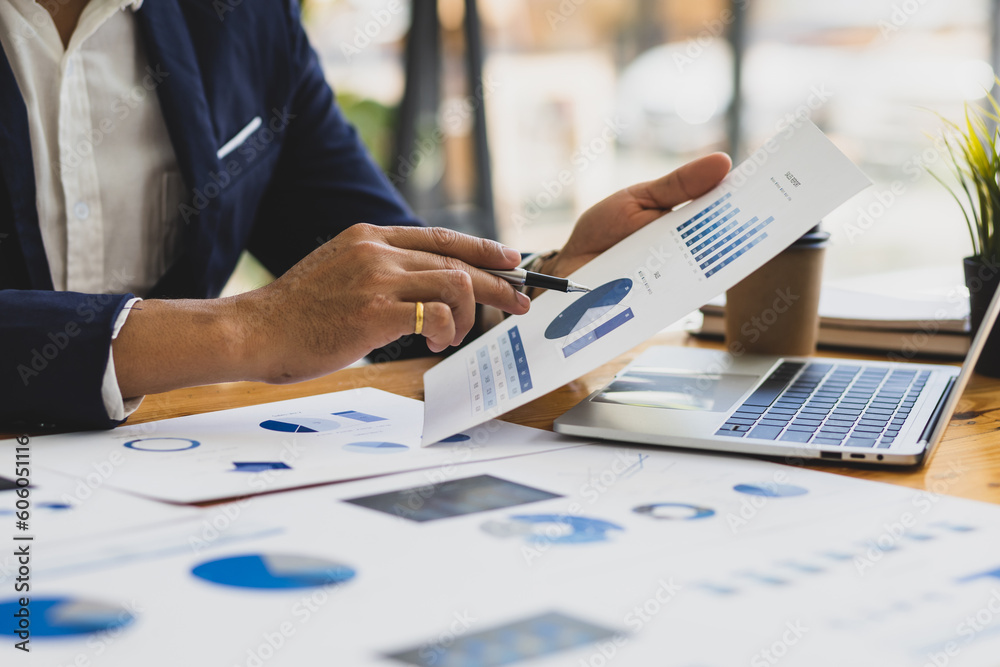 Businessman working on documents on the desk, data analysis of financial figures and business invest