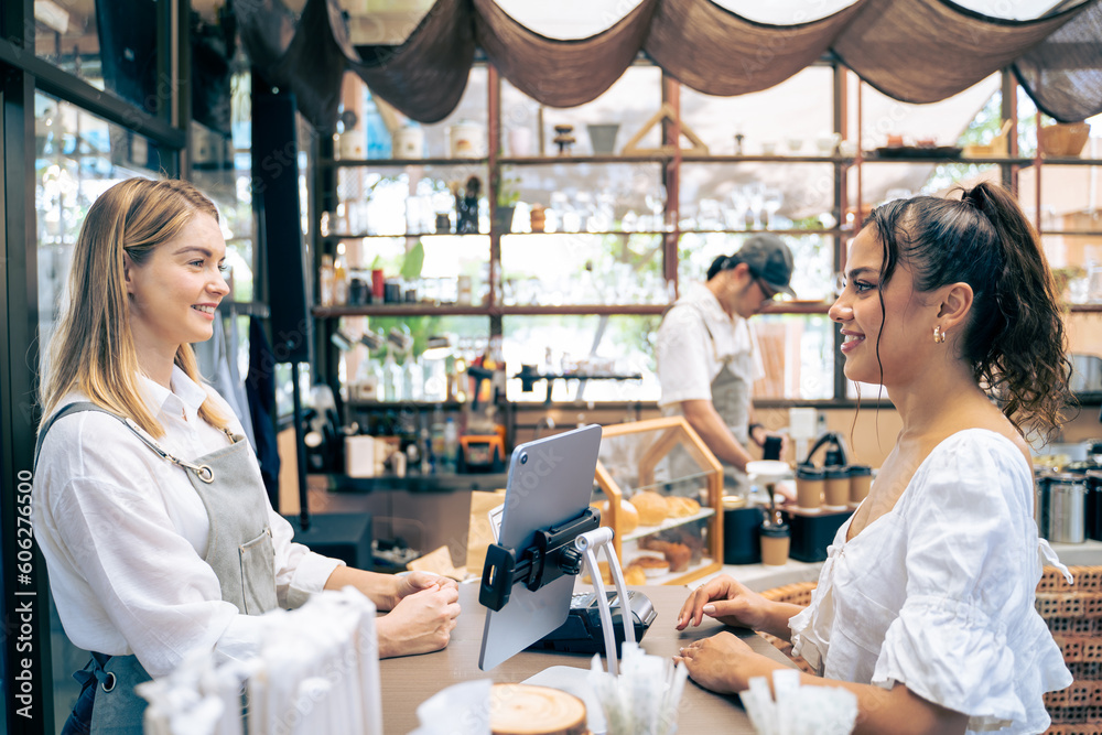 Caucasian young female barista or waitress working in the coffeehouse. 