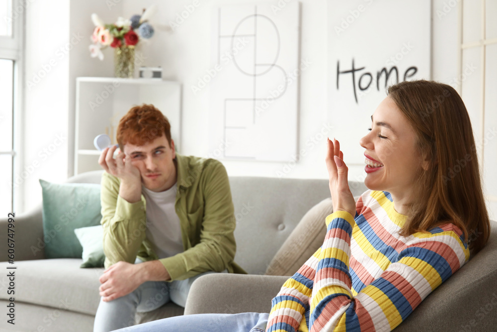 Laughing young woman get proposed at home