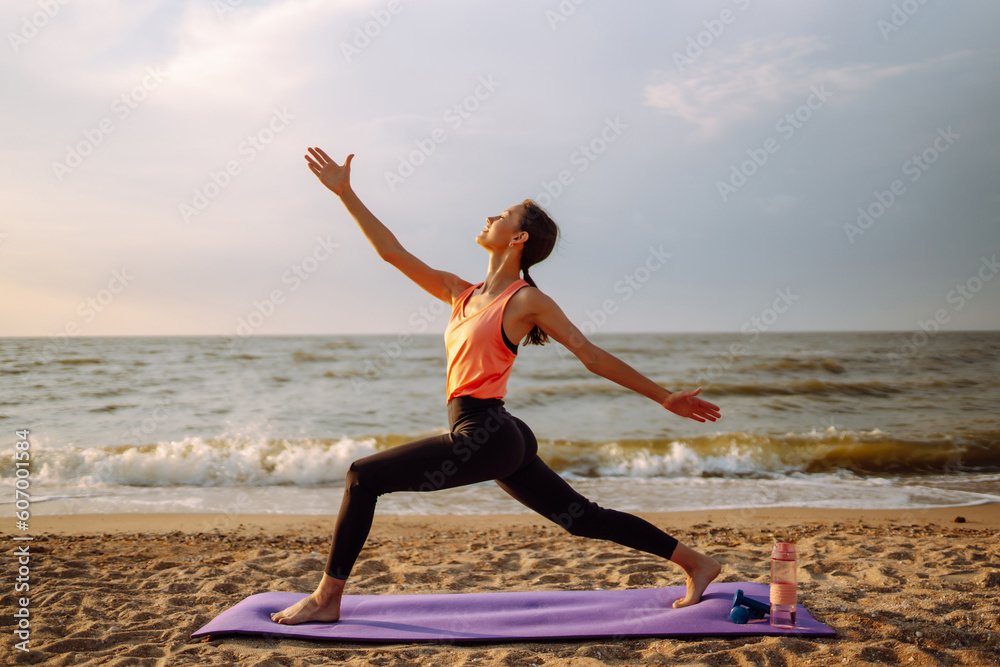 A sporty woman does exercises in the open air. Healthy lifestyle, sports activities in the morning i