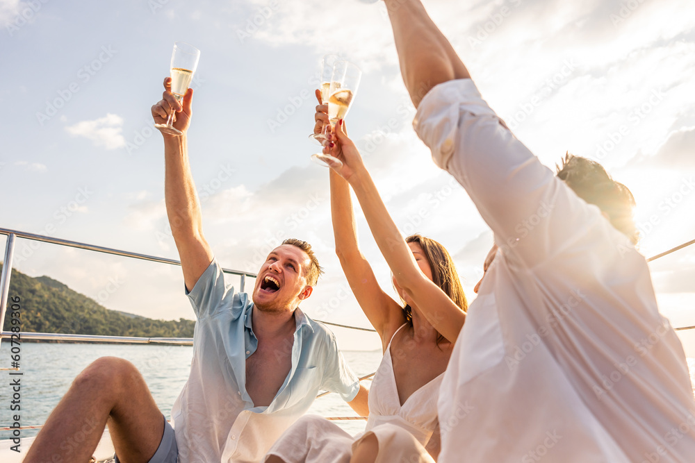 Group of diverse friends drink champagne while having a party in yacht. 