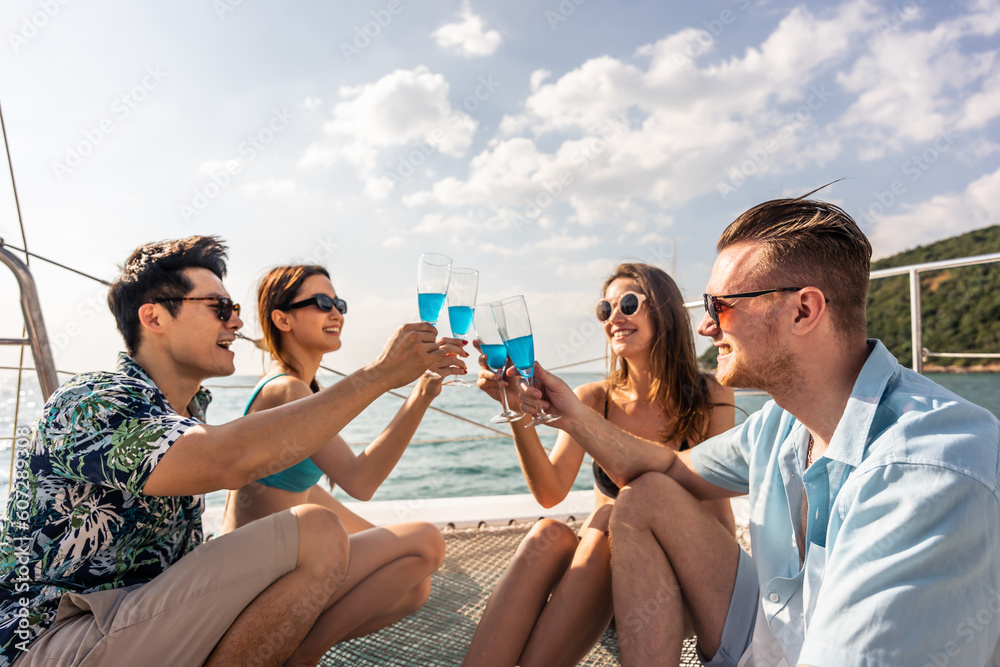 Group of diverse friends drink champagne while having a party in yacht. 