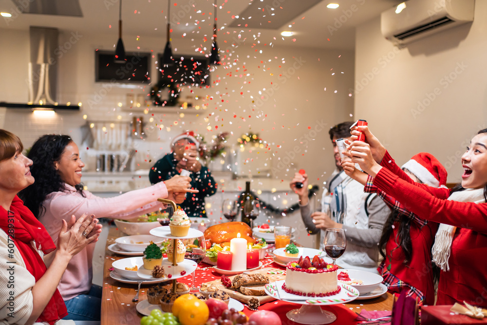 Multi-ethnic big family celebrating Christmas party together in house. 